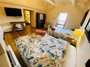 a living room with a bed and a flat screen tv at Cusco Hotel Boutique in Cusco +32 photos