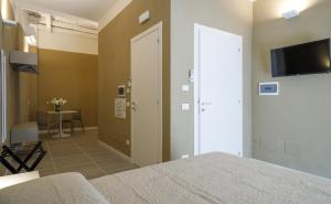 a bedroom with a bed and a tv on a wall at Palazzo Mancina in Trapani