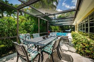 a patio with a table and chairs and a pool at Sunset Beach House in Clearwater Beach