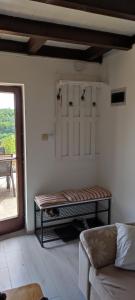 a living room with a bench in a room with a window at Mrežnica - Zelena oaza II in Generalski Stol