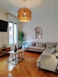 a living room with a couch and a table at Railway by Staynnapartments in Bilbao