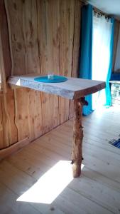 Cette chambre comprend une table en bois et un lavabo bleu. dans l'établissement Schiefe Hütte am Attersee., à Lenzing