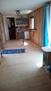 a room with a wooden floor and a table at Schiefe Hütte am Attersee. in Lenzing