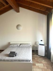 a white bedroom with a white bed and a table at Casa Cleopatra in Bergamo