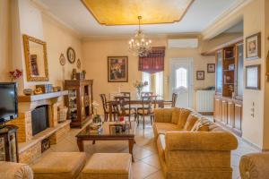 a living room with a couch and a table at Sevi's Luxury Guesthouse Villa in Ioannina