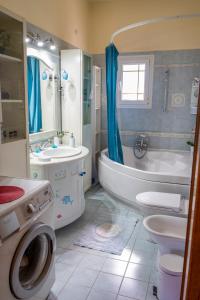 a bathroom with a tub and a toilet and a sink at Sevi's Luxury Guesthouse Villa in Ioannina
