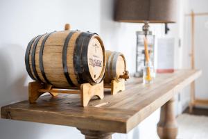 two wine barrels sitting on top of a wooden table at Modern Apt Near Downtown Burlington Ideal for long stays - U2 - The Blair in Burlington