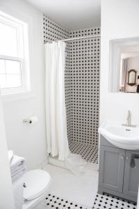 a white bathroom with a toilet and a sink at Modern Apt Near Downtown Burlington Ideal for long stays - U2 - The Blair in Burlington
