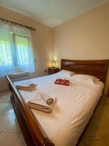 a bed with two towels and two candles on it at Lovely apartment Jovan 3,with a view of the bay and free Wi-Fi in Kotor +21 photos