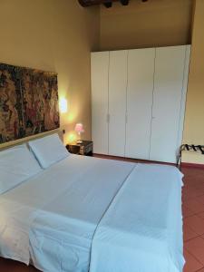 a bedroom with a large bed with white cabinets at CASA DUCHESSE al Castello in Ferrara