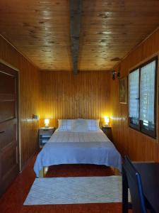 a bedroom with a bed in a wooden room at Rest House Korana in Karlovac