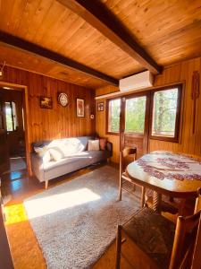 a room with a bed and a table in a cabin at Rest House Korana in Karlovac