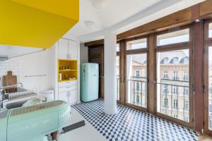 a kitchen with a sink and a large window at THE BUILDING - Appartement d'architecte avec vue Notre Dame de la Garde in Marseille