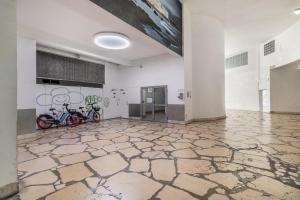 two bikes parked in a room with a painting on the wall at THE BUILDING - Appartement d'architecte avec vue Notre Dame de la Garde in Marseille