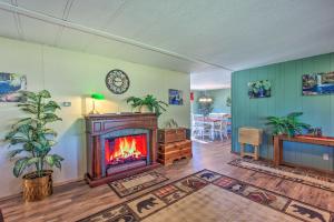 a living room with a fireplace and a dining area at Cozy Chiloquin Retreat Less Than 30 Mi to Crater Lake! in Chiloquin