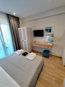 Postel nebo postele na pokoji v ubytování CONMARI LUXURY STUDIOS