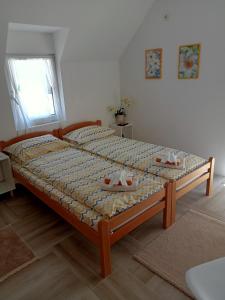 a bedroom with a bed with two shoes on it at Vila Danida in Žabljak