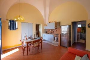 a kitchen with a table and chairs in a room at Residenza delle Palme in Pantelleria