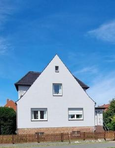 a white house with a black roof at Haus Frida in Barth