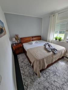 a bedroom with a bed and a window at Haus Frida in Barth
