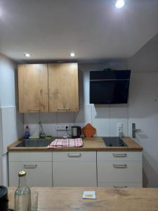 a kitchen with white cabinets and a wooden counter top at Rheinapartment 8 in Bad Hönningen