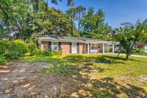 a brick house with a tree in the yard at Pet-Friendly Brunswick Retreat with Gas Grill! in Brunswick