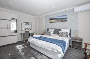 a bedroom with a bed and a desk in it at Casa Milner Guest House in Cape Town
