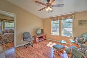 a living room with a ceiling fan and a tv at Secluded Durango Cabin about 11 Mi to Downtown! in Durango