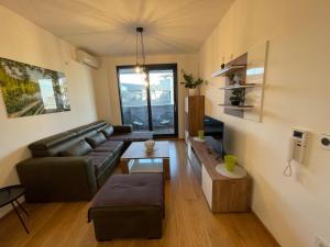 a living room with a couch and a table at Fantastic centar Novi Sad in Novi Sad