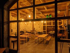 a large room with wooden tables and benches at Hinterland Hostel in Rathen