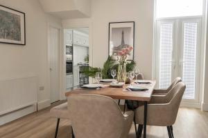 a dining room with a wooden table and chairs at The Callie by Sasco Apartments in Blackpool