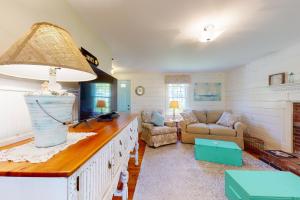 a living room with a couch and a table at Dennis Port Delight in Dennis Port