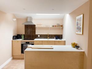 a kitchen with a stove and a counter top at Luxury bolthole in central St.Agnes with parking. in St. Agnes