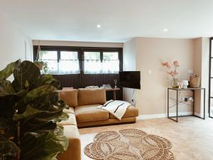 a living room with a couch and a tv at Luxury bolthole in central St.Agnes with parking. in St. Agnes