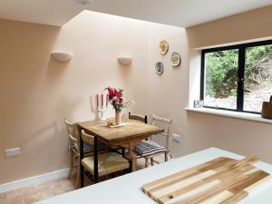 a dining room with a wooden table and chairs at Luxury bolthole in central St.Agnes with parking. in St. Agnes