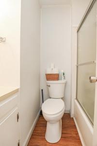a white bathroom with a toilet and a shower at Spacious Home with Waterfront View-Welcome Pets in Sneads Ferry