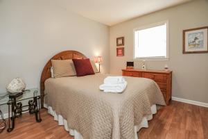 a bedroom with a bed with towels on it at Spacious Home with Waterfront View-Welcome Pets in Sneads Ferry