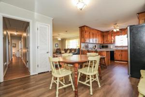a kitchen and dining room with a table and chairs at Spacious Home with Waterfront View-Welcome Pets in Sneads Ferry