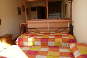 a bedroom with a bed with a colorful quilt at Estudio con vistas Edificio Bulgaria in Sierra Nevada