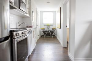 a kitchen with a sink and a stove at Modern Apt Near Downtown Ideal for long stays - U3 - The Deco in Burlington