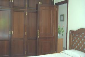 a pair of wooden closet doors in a bedroom at APARTAMENTO AVDA. LAS ARTES in Puerto de Mogán