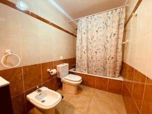 a bathroom with a toilet and a shower curtain at Holiday for you Callao in Callao Salvaje +12 photos