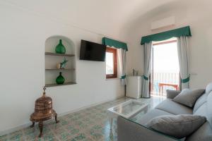 a living room with a couch and a table at Villa Nettuno in Positano
