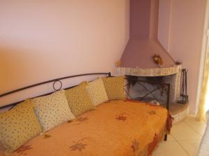 a bedroom with a bed with a fireplace at Sapera Evdokia in Filiatra