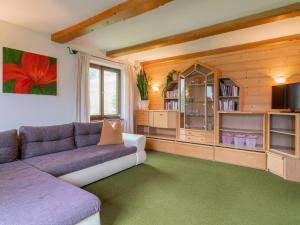 a living room with a couch and a tv at Katharina in Brixen im Thale