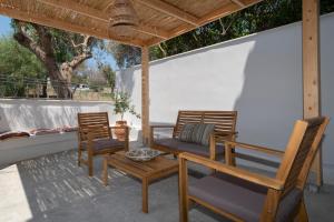 twee stoelen en een tafel op een patio bij Camara Luxury Apartments (Deluxe Apartment) in Pylos