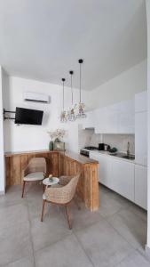 a kitchen with a table and two chairs and a counter at Dimora Giusti in Lecce