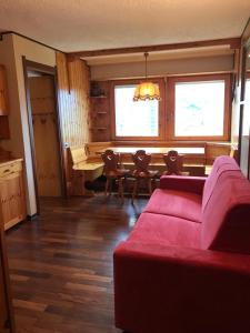 a living room with a couch and a dining table at Finestra sull’Adamello in Passo del Tonale