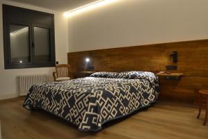 a bedroom with a bed and a desk at Hotel Gran Sol in Solsona