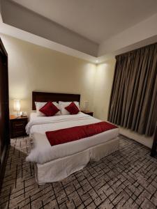 A bed or beds in a room at بيت السائح Tourist Home